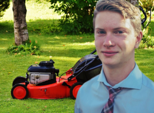 Student standing next to mower