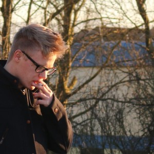 liberal teen smoking cigarette deep in thought