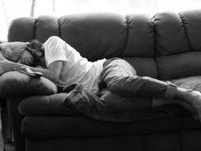 Man asleep on his parent's couch